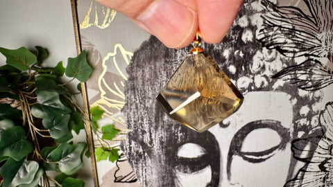 A close-up of a natural citrine crystal pendant from the Crystals & Reiki collection, showcasing its golden colour and clarity.